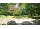 Landscaped backyard featuring mature trees and green grass at 6600 Sadie Dr, Wendell, NC 27591