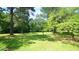 Lush backyard with mature trees and ample space for outdoor activities at 6600 Sadie Dr, Wendell, NC 27591