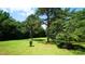 Lush backyard with mature trees and green grass at 6600 Sadie Dr, Wendell, NC 27591