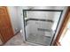 Modern shower with a mosaic tile floor, sleek glass door and a built-in bench at 6600 Sadie Dr, Wendell, NC 27591
