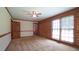 Bedroom features log walls, neutral carpet, overhead fan, and two windows for lots of natural light at 6600 Sadie Dr, Wendell, NC 27591