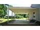 Large carport area next to the house with an entrance and backyard view at 6600 Sadie Dr, Wendell, NC 27591