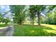 Scenic driveway leading to a property surrounded by mature trees and greenery at 6600 Sadie Dr, Wendell, NC 27591