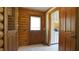 Interior entryway featuring tile flooring, wooden doors, and log walls at 6600 Sadie Dr, Wendell, NC 27591