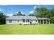 Back of the home with a large lawn, screened in porch and a carport at 6600 Sadie Dr, Wendell, NC 27591