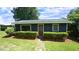 Charming home with blue siding, a red door, and well-manicured landscaping at 6600 Sadie Dr, Wendell, NC 27591
