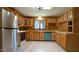 Bright kitchen with wooden cabinets, modern appliances, and tile flooring throughout at 6600 Sadie Dr, Wendell, NC 27591