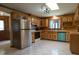 Traditional kitchen with stainless steel appliances, wood cabinets, and tile flooring for easy maintenance at 6600 Sadie Dr, Wendell, NC 27591