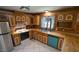 Well-lit kitchen with wooden cabinets, stainless steel refrigerator, and modern appliances at 6600 Sadie Dr, Wendell, NC 27591