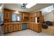 Kitchen with wooden cabinets, tile flooring, and a window overlooking the backyard at 6600 Sadie Dr, Wendell, NC 27591