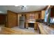 Corner view of kitchen with wooden cabinets, stainless steel refrigerator, and tile flooring at 6600 Sadie Dr, Wendell, NC 27591