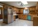 Charming kitchen with stainless steel appliances, light wood cabinets, and tile flooring at 6600 Sadie Dr, Wendell, NC 27591