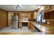 Spacious kitchen featuring wooden cabinets, stainless steel refrigerator, and tile flooring at 6600 Sadie Dr, Wendell, NC 27591