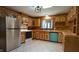 Efficient kitchen with stainless steel fridge and ample cabinetry space, complemented by bright tile flooring at 6600 Sadie Dr, Wendell, NC 27591