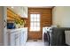 Sunlit laundry room features a modern washer, dryer and white cabinets with counter space at 6600 Sadie Dr, Wendell, NC 27591