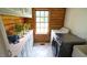 Bright laundry room features a window, white appliances, white cabinetry and tile flooring at 6600 Sadie Dr, Wendell, NC 27591