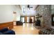 Open living room featuring stone fireplace, hardwood floors, and natural lighting at 6600 Sadie Dr, Wendell, NC 27591