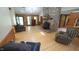 Spacious living room with wood floors, a stone fireplace, and natural light through large windows at 6600 Sadie Dr, Wendell, NC 27591