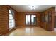 Inviting living room with log walls, wood floors, and access to the outdoors through glass doors at 6600 Sadie Dr, Wendell, NC 27591