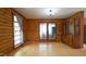 Inviting living room with log walls, wood floors, and access to the outdoors through glass doors at 6600 Sadie Dr, Wendell, NC 27591
