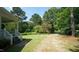 Landscaped side yard and pathway leading to a charming home at 6600 Sadie Dr, Wendell, NC 27591