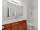 Bathroom with vanity, marble countertop, mirror and step-in shower at 6809 Middleboro Dr Dr, Raleigh, NC 27612