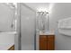 Bright bathroom featuring a glass-enclosed shower and wood vanity cabinet at 6809 Middleboro Dr Dr, Raleigh, NC 27612