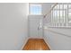Bright foyer with hardwood floors, white door, and staircase at 6809 Middleboro Dr Dr, Raleigh, NC 27612
