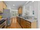 Kitchen with granite countertops, stainless steel appliances, and hardwood floors at 6809 Middleboro Dr Dr, Raleigh, NC 27612