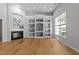 Bright living room features hardwood floors, fireplace, and custom built-in shelving at 6809 Middleboro Dr Dr, Raleigh, NC 27612