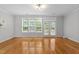 Living room with a doorway to a deck, neutral walls, and hardwood floors at 6809 Middleboro Dr Dr, Raleigh, NC 27612
