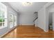 Hardwood floors, natural light, neutral walls, and stairs accent this living room at 6809 Middleboro Dr Dr, Raleigh, NC 27612