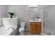 Well-lit main bathroom featuring a soaking tub, shower, and vanity at 6809 Middleboro Dr Dr, Raleigh, NC 27612