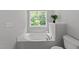 Bright bathtub area with a plant near the window at 6809 Middleboro Dr Dr, Raleigh, NC 27612