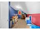Cozy unfinished attic space with carpet, blue and red accents, and storage options at 82 Finley Ct, Clayton, NC 27520