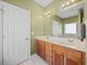Bathroom featuring dual sinks with wood cabinets, a large mirror and overhead lights at 82 Finley Ct, Clayton, NC 27520