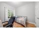 Bedroom with hardwood floors, a desk, a cozy bed, and lots of natural light at 82 Finley Ct, Clayton, NC 27520