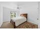 Bright bedroom featuring a queen-sized bed, ceiling fan, and large window with natural light at 82 Finley Ct, Clayton, NC 27520