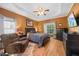 Spacious bedroom with a tray ceiling, ceiling fan, wood floors, and TV at 82 Finley Ct, Clayton, NC 27520