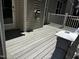 A backyard deck featuring composite boards and white railings with access to a door at 82 Finley Ct, Clayton, NC 27520