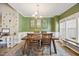 Elegant dining room features wainscoting, a decorative chandelier, and large windows at 82 Finley Ct, Clayton, NC 27520