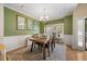 Stylish dining room with a rustic table and chairs, bright natural light, and decorative rug at 82 Finley Ct, Clayton, NC 27520