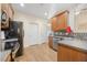 Traditional kitchen featuring wood cabinets, stone countertops and stainless steel appliances at 82 Finley Ct, Clayton, NC 27520
