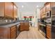 Well-appointed kitchen with stainless steel appliances, wood cabinetry, and modern backsplash at 82 Finley Ct, Clayton, NC 27520