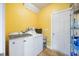 Laundry room with a washer, dryer, storage shelves, and a door to the outside at 82 Finley Ct, Clayton, NC 27520