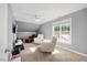 Cozy living room with a ceiling fan, comfortable seating, and large windows at 82 Finley Ct, Clayton, NC 27520