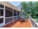 Spacious screened back porch featuring a wood deck and views of the backyard at 9048 Chelsea Dr, Raleigh, NC 27603