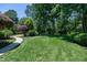Expansive lawn featuring mature trees and landscaping, great for outdoor activities at 9048 Chelsea Dr, Raleigh, NC 27603