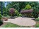 Backyard patio with fire pit and lush trees creates a serene outdoor living space for relaxing and entertaining at 9048 Chelsea Dr, Raleigh, NC 27603