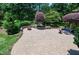 An expansive patio with lush landscaping and mature trees provides a peaceful and inviting outdoor entertaining space at 9048 Chelsea Dr, Raleigh, NC 27603
